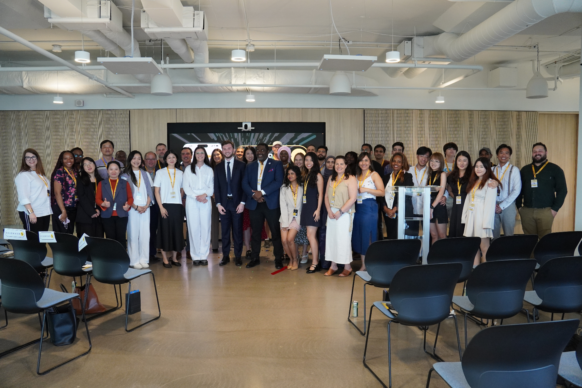 The ImmigrateAI Global team and community standing together at a launch event